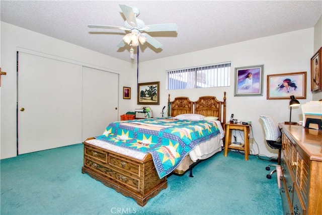 carpeted bedroom with a ceiling fan, a closet, and a textured ceiling