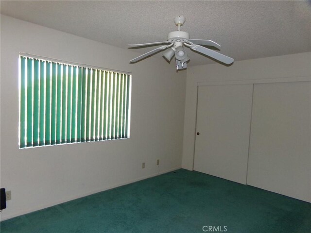 61615 El Cajon Dr, Joshua Tree, CA 92252 - spare room featuring a textured ceiling, ceiling fan, and carpet
