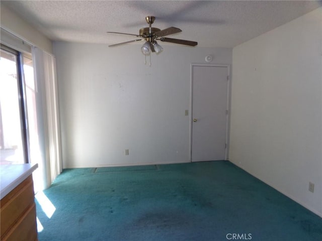 61615 El Cajon Dr, Joshua Tree, CA 92252 - empty room featuring a ceiling fan, carpet, and a textured ceiling