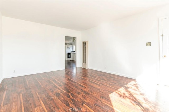 empty room featuring baseboards and wood finished floors