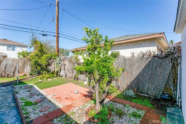 view of yard with fence and a patio area