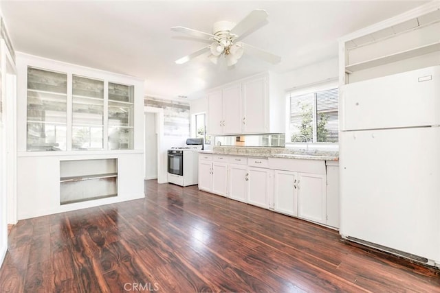 kitchen featuring dark wood-style floors, white cabinets, and white appliances