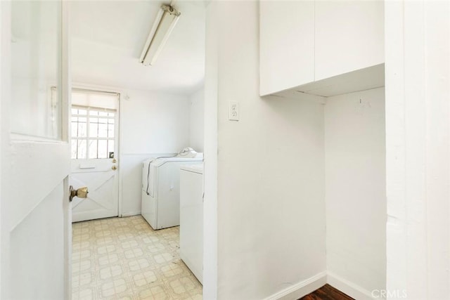 washroom with laundry area, light floors, independent washer and dryer, and baseboards