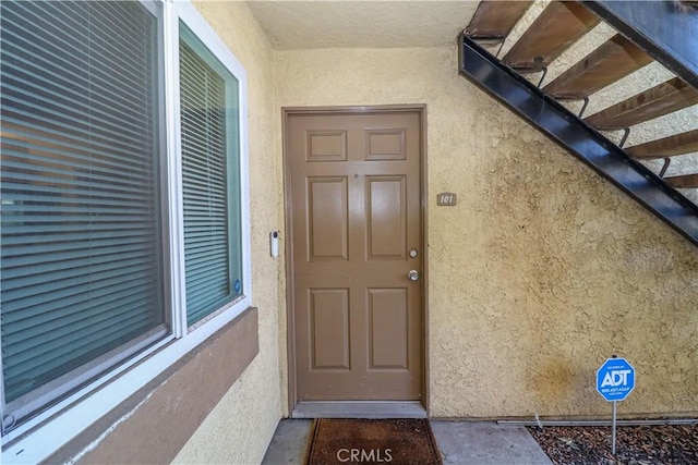 entrance to property with stucco siding