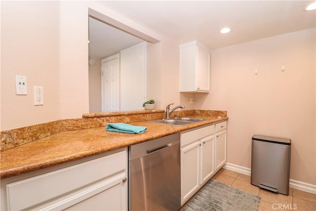 kitchen featuring light countertops, light tile patterned floors, stainless steel dishwasher, white cabinetry, and a sink