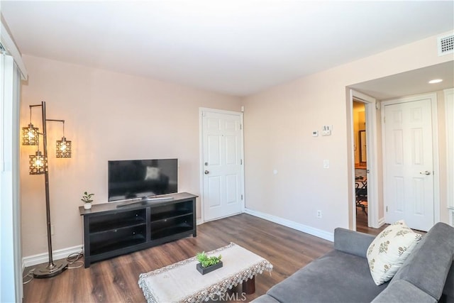 living area featuring baseboards and wood finished floors