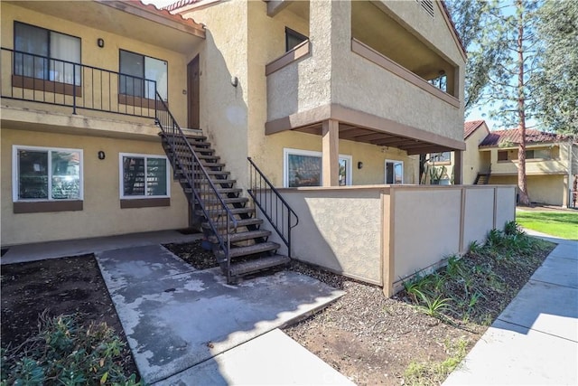 property entrance with stucco siding