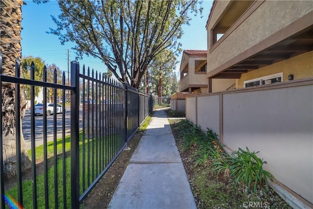 view of property's community featuring a gate and fence