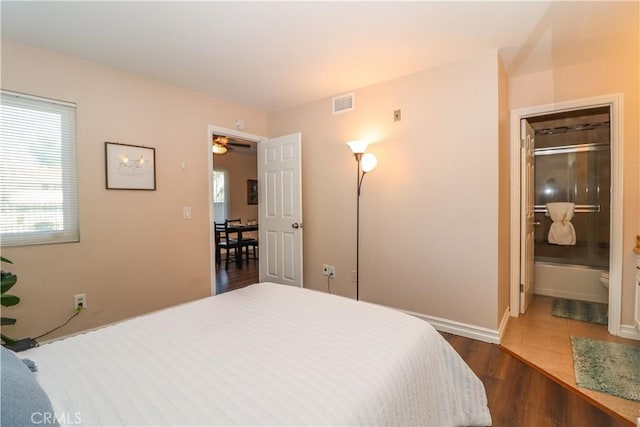 bedroom featuring visible vents and dark wood finished floors