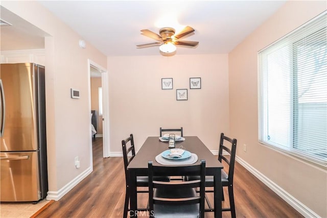 dining room with baseboards, dark wood-style flooring, and a ceiling fan