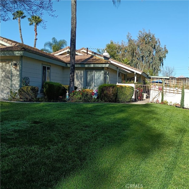 view of home's exterior featuring a yard and fence