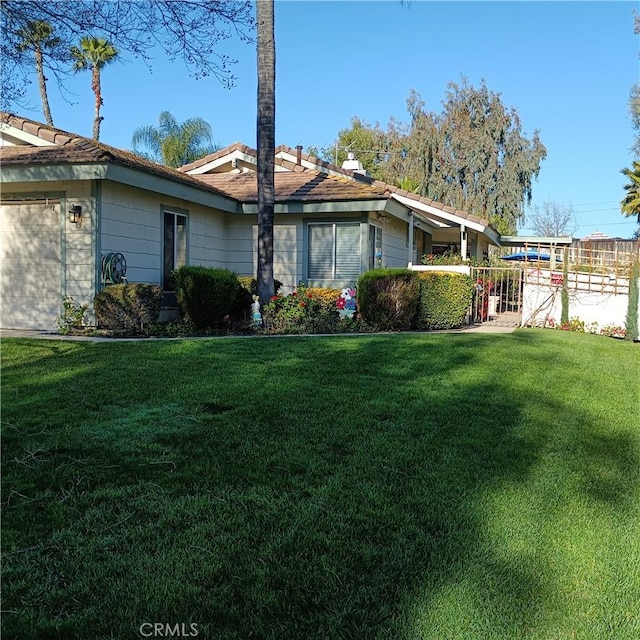 view of property exterior featuring a lawn and an attached garage