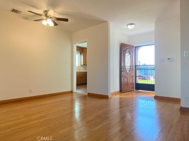 entrance foyer with light wood-type flooring and baseboards