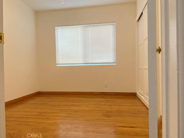 unfurnished bedroom featuring baseboards and light wood-style floors