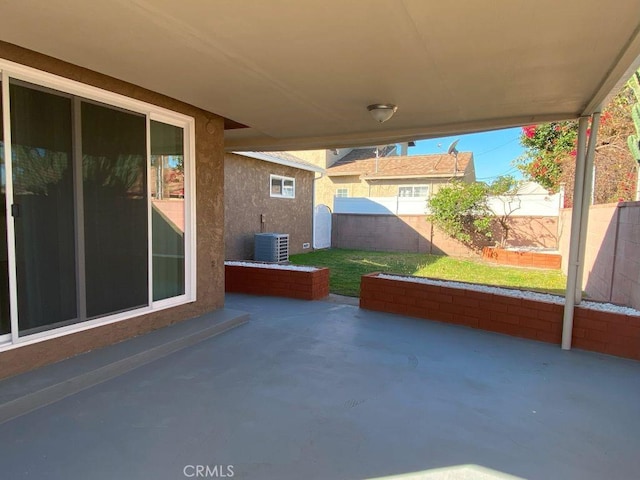 view of patio featuring central AC unit and fence