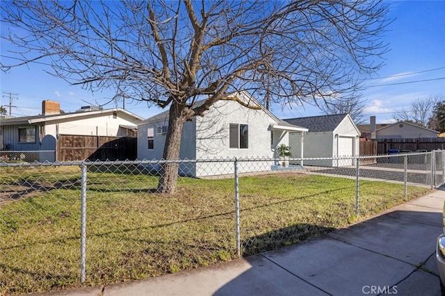 view of property exterior featuring a fenced front yard, a lawn, and concrete driveway