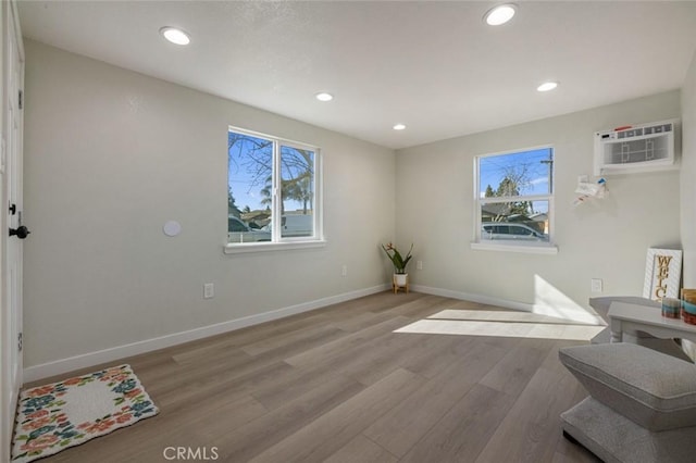 interior space featuring recessed lighting, baseboards, light wood-type flooring, and a wealth of natural light