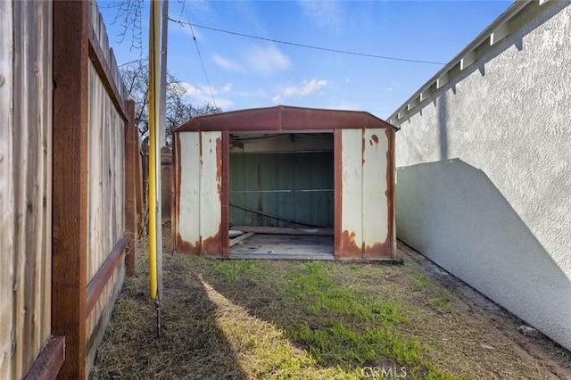 view of shed featuring fence