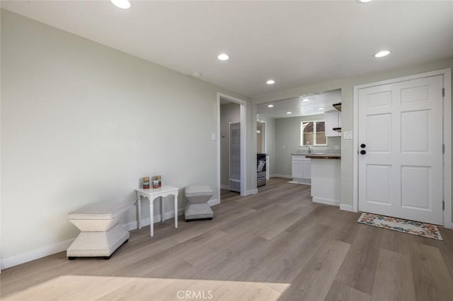 sitting room featuring recessed lighting, baseboards, and light wood-style floors