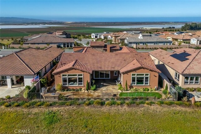 drone / aerial view with a residential view and a water view