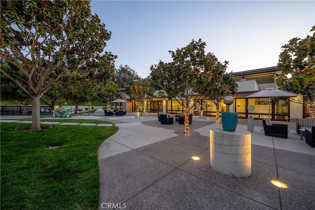 view of community with a patio area, an outdoor hangout area, and a yard