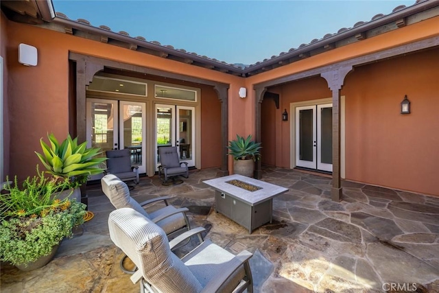 view of patio / terrace featuring french doors and a fire pit