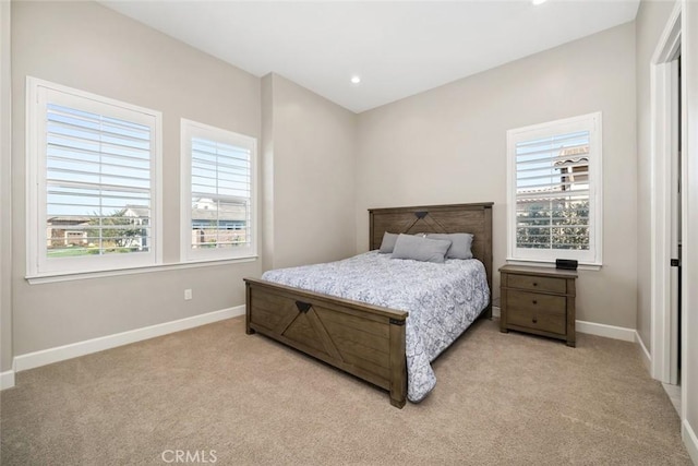 bedroom with recessed lighting, light colored carpet, and baseboards