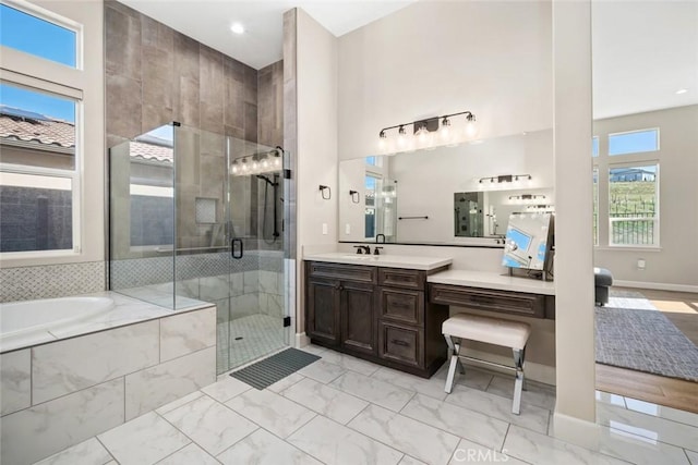 bathroom featuring marble finish floor, a stall shower, a bath, a towering ceiling, and vanity