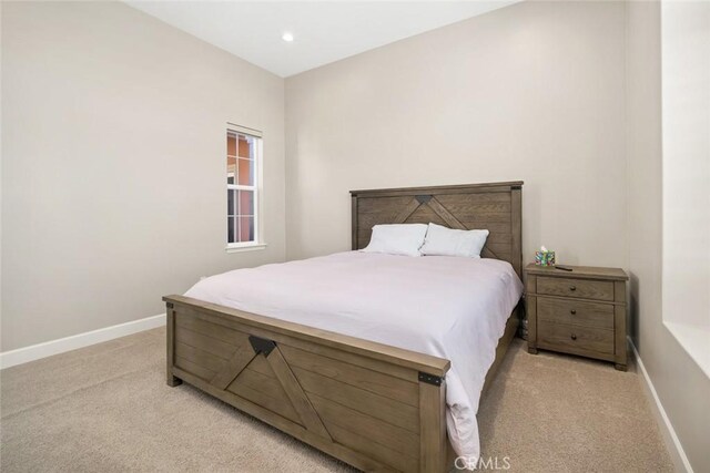 bedroom featuring light carpet, recessed lighting, and baseboards