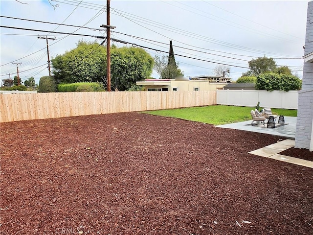 view of yard with a patio area and a fenced backyard