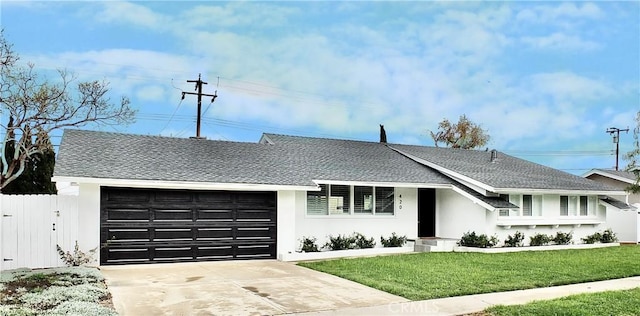 view of front of home with roof with shingles, driveway, an attached garage, stucco siding, and a front lawn