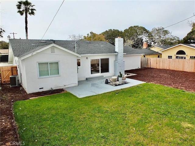 back of house with roof with shingles, central AC unit, a yard, a fenced backyard, and a patio area