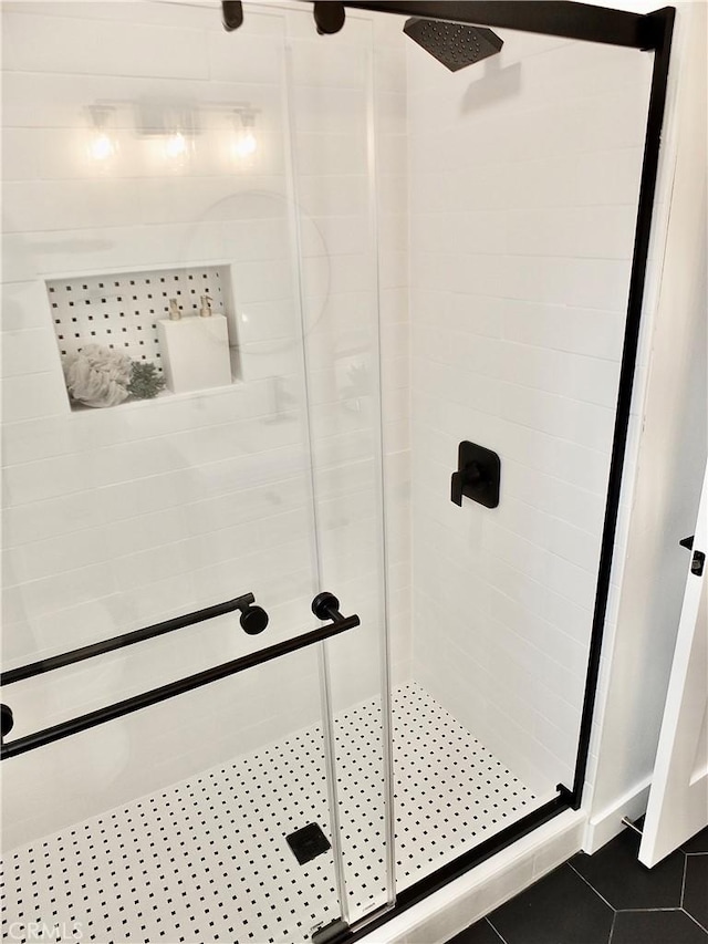 bathroom featuring tile patterned floors and a shower stall