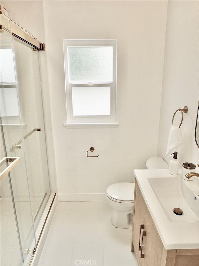 full bathroom featuring a shower stall, baseboards, toilet, tile patterned floors, and vanity