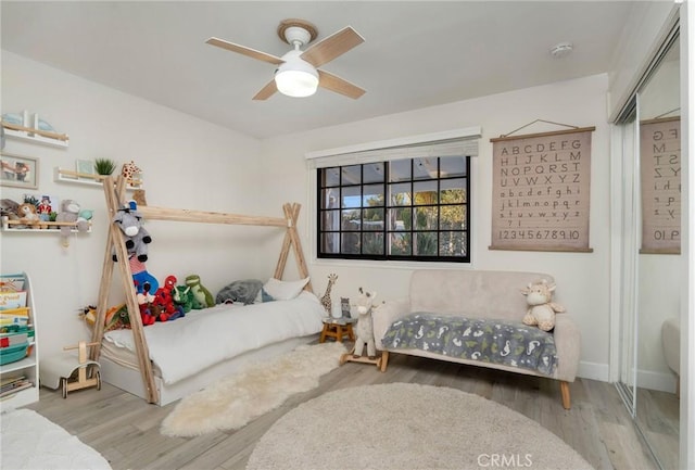 bedroom featuring ceiling fan and wood finished floors