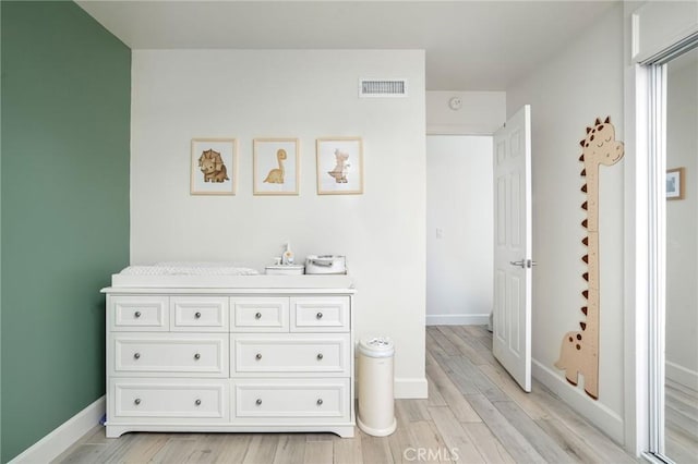 bathroom featuring visible vents, baseboards, and wood finished floors