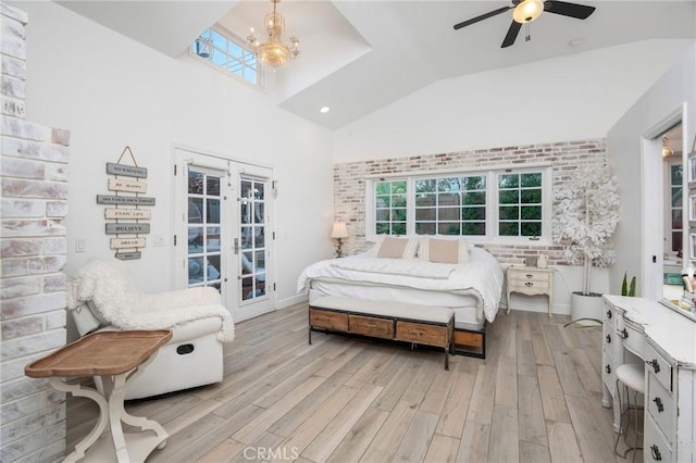 bedroom featuring access to exterior, french doors, light wood-style floors, and brick wall