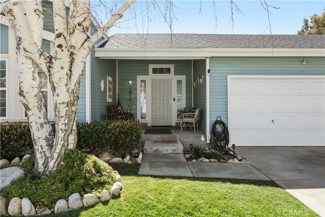 doorway to property featuring a garage, driveway, and roof with shingles