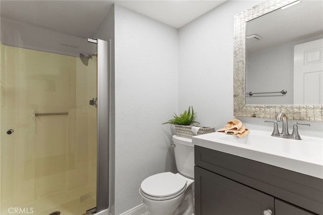 bathroom with a shower stall, toilet, and vanity