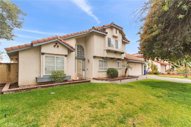 mediterranean / spanish house with a front yard, stucco siding, concrete driveway, a garage, and a tile roof