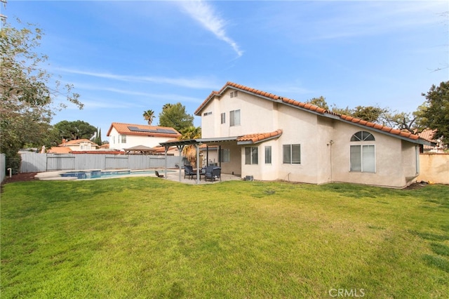 rear view of property with a yard, a fenced in pool, a fenced backyard, and a patio area