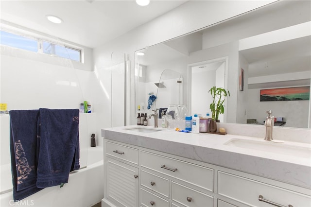 full bath with double vanity, shower / bath combination, recessed lighting, and a sink