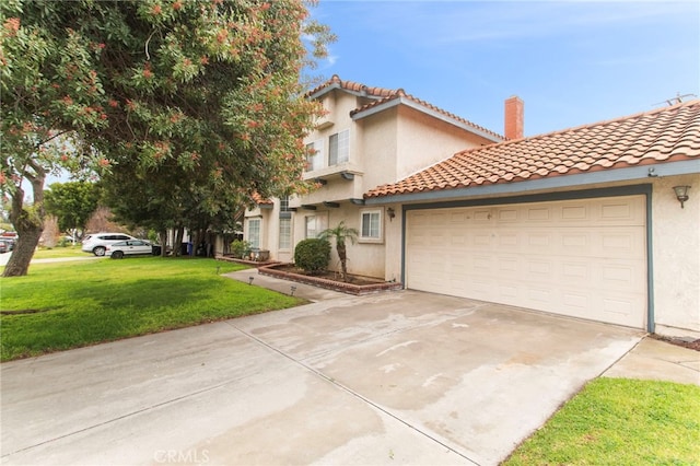 view of front of home with driveway, stucco siding, a front lawn, a garage, and a tile roof