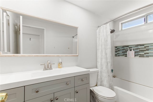 full bathroom with vanity, shower / bath combination with curtain, and toilet