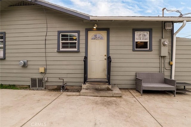 doorway to property with visible vents and a patio