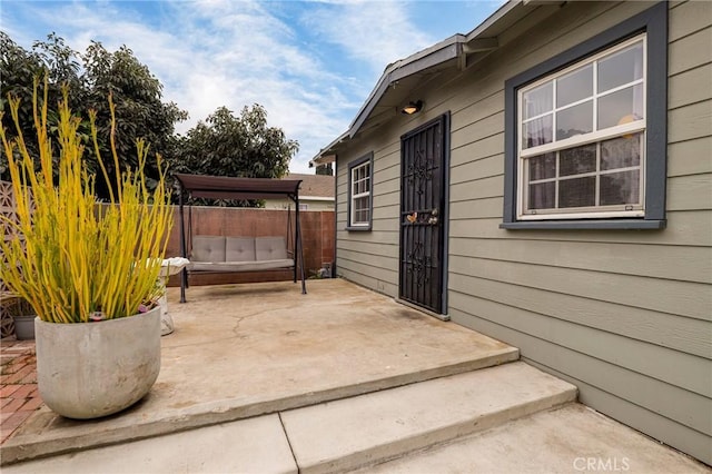 view of patio / terrace featuring fence