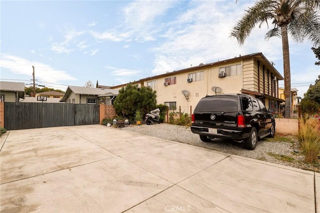 exterior space featuring stucco siding and fence