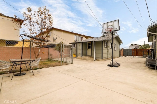 view of sport court featuring a gate and fence