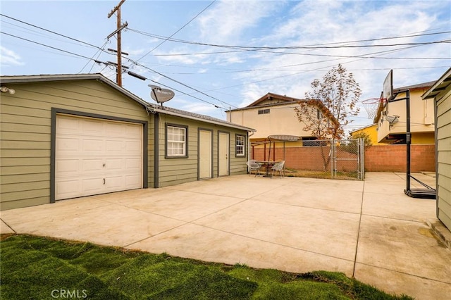 detached garage featuring fence