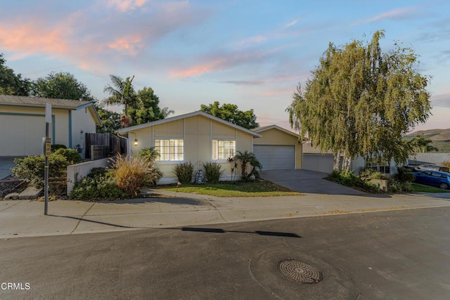 ranch-style house featuring concrete driveway and an attached garage